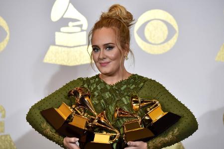 Singer Adele appears backstage with her awards for Album Of... Singer Adele appears backstage with her awards for Album Of...