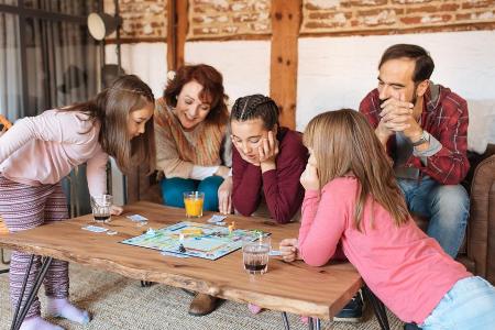 Mit der ganzen Familie ein Brettspiel spielen, ist ein toller Zeitvertreib Mit der ganzen Familie ein Brettspiel spielen, ist ein toller Zeitvertreib