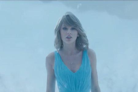 Im blauen Kleid schreitet Taylor Swift durch eine Schneelandschaft Im blauen Kleid schreitet Taylor Swift durch eine Schneelandschaft