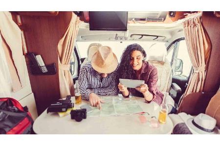 Mid adult couple planning road trip in campervan Mid adult couple planning road trip in campervan