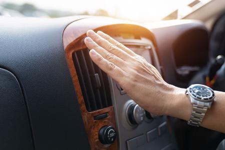 Hand checking the air conditioner in the car, The cooling system in the car