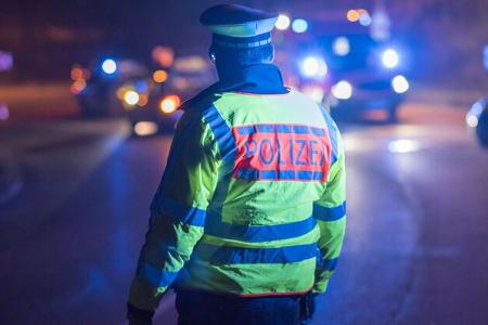 Police officer regulates traffic in a traffic accident, Stuttgart, Germany