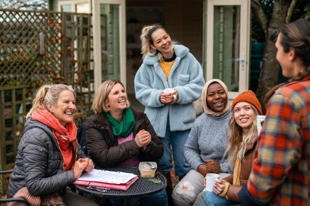Fruppe von Frauen verschiedener Herkunft und unterschiedlichen Alters am Diskutieren