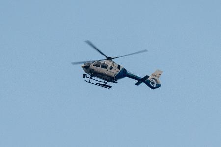 Ein Polizeihubschrauber fliegt über den Ortsrand in Parsberg.